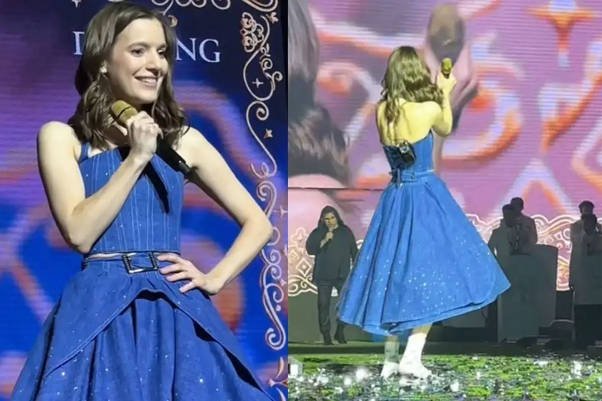 Sanah w niebieskiej sukience z błyszczącymi detalami, z mikrofonem w dłoni. Jej wzrost pozwala jej błyszczeć na scenie.